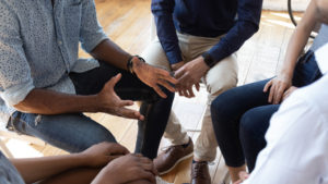 Multi-racial group in a circle